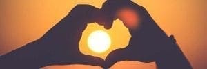 solar panels - the power of the sun shown through hands shaped a hear